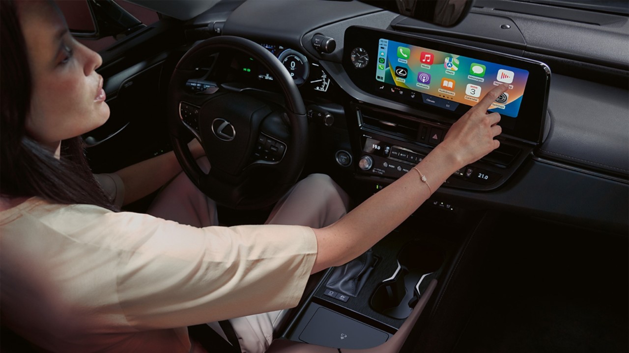 A woman using the multimedia screen within the Lexus ES